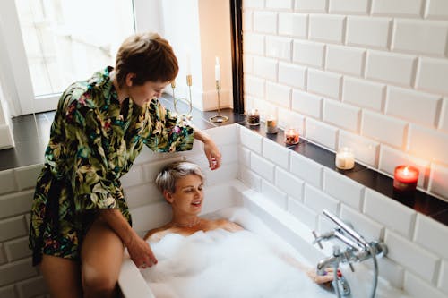 A Woman Lying in the Bathtub Filled with Soapy Water