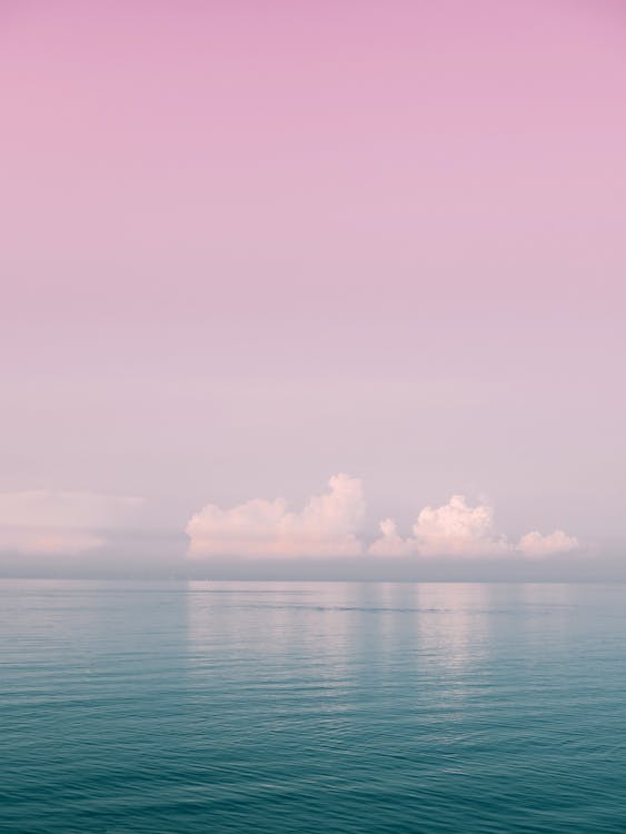 Photograph of a Body of Water Under a Pink Sky · Free Stock Photo