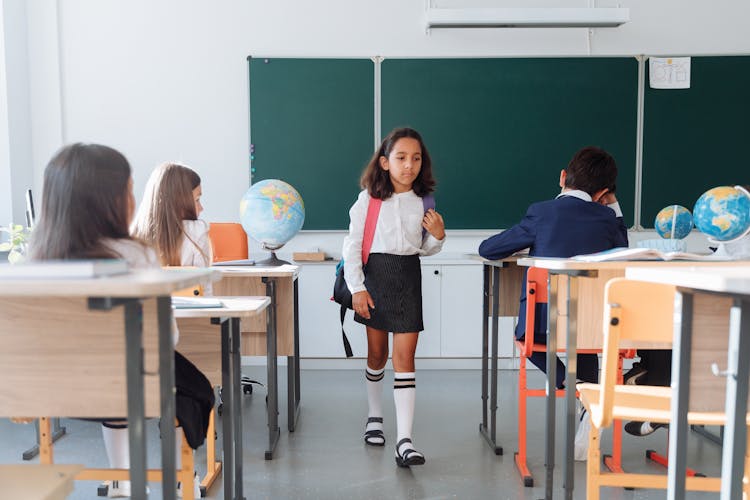 A Girl Walking Inside The Classroom