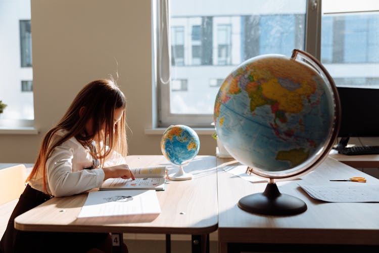 Side View Of A Student Studying About Geography