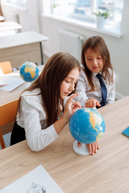 Two Girls Studying a Globe