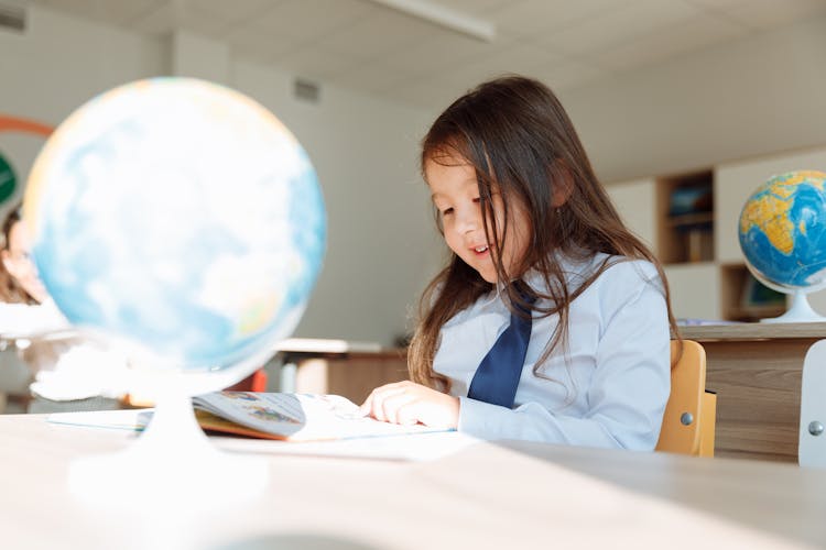 A Smiling Student Studying About Geography