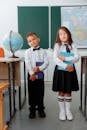 Students in School Uniform Holding Books