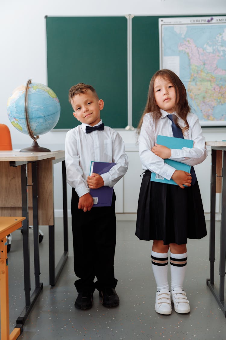 Students In School Uniform Holding Books