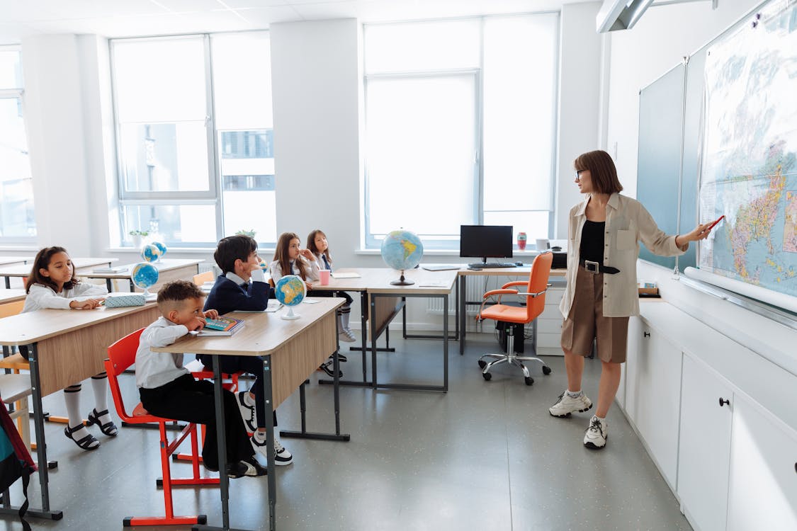 Free Teacher Discussing Her Lesson About Geography Stock Photo