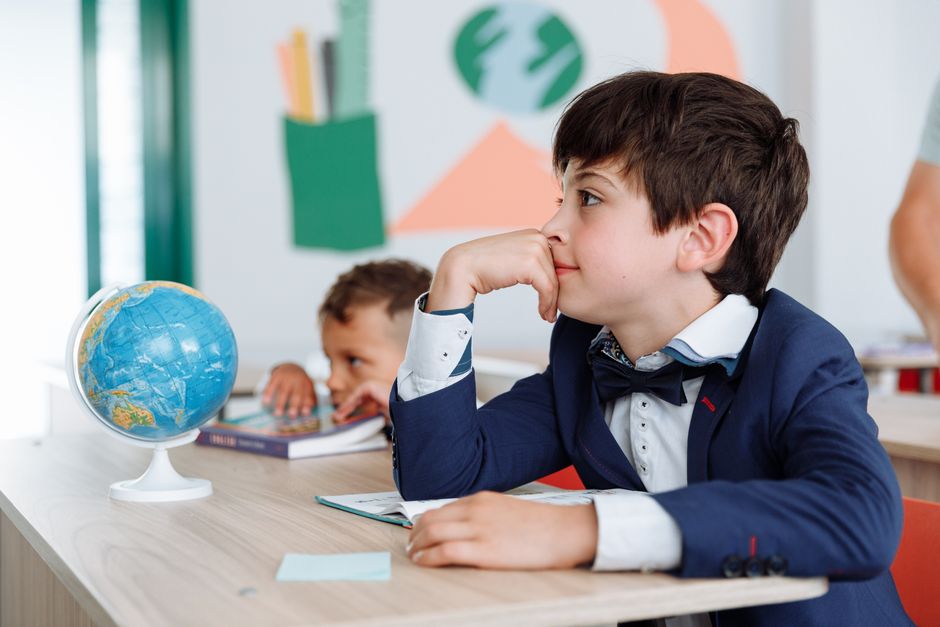 Photo by Thirdman on Pexels Two boys engaged in a classroom setting with books and a globe, learning about geography. - Photo by Thirdman on Pexels
