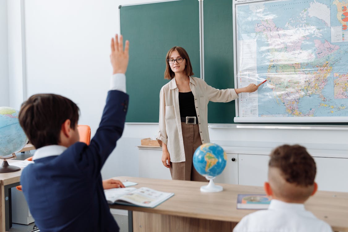 Free Teacher Discussing Her Lesson About Geography Stock Photo