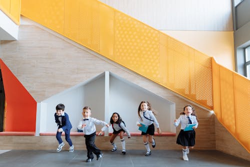 Free Students Running Together Inside the School Stock Photo