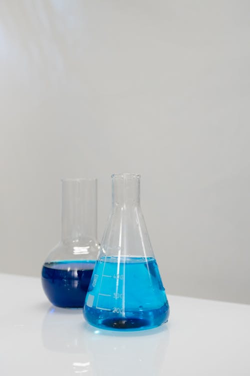 Flasks with Blue Liquid on a Table