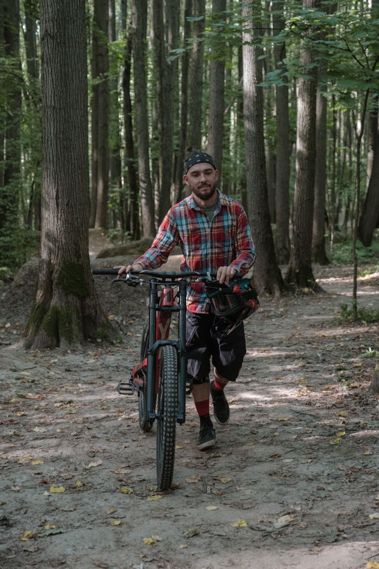 Man Walking With A Bike