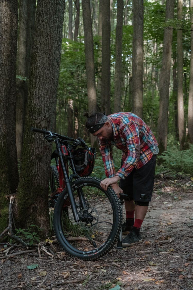 Man Checking The Bike Tire