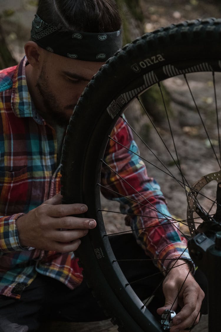 Man Fixing The Tire Of His Bike 