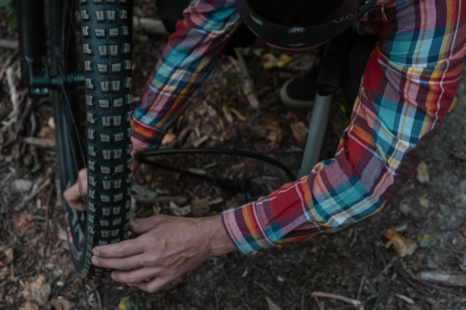 Cyclist checking a mountain bike wheel and tire