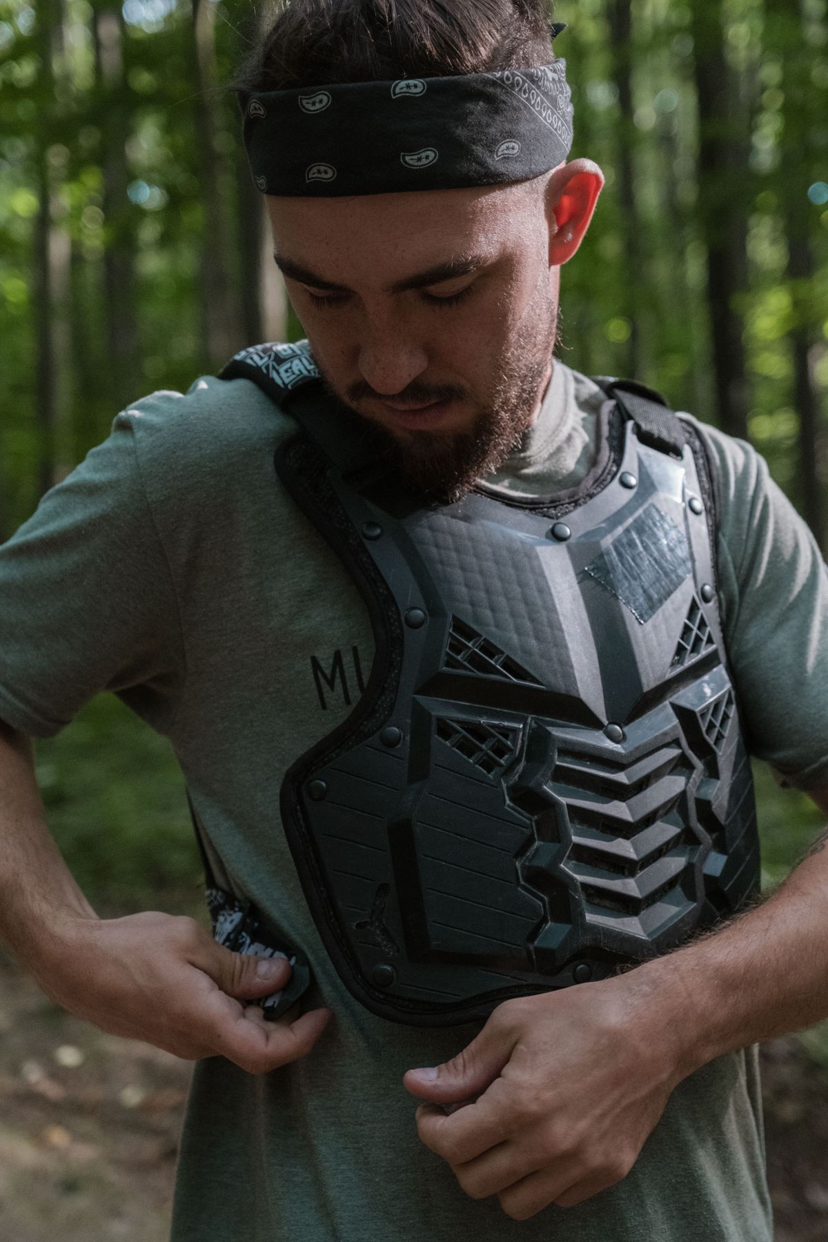 Rider fitting black chest protector body armor for off-road ATV riding safety protection