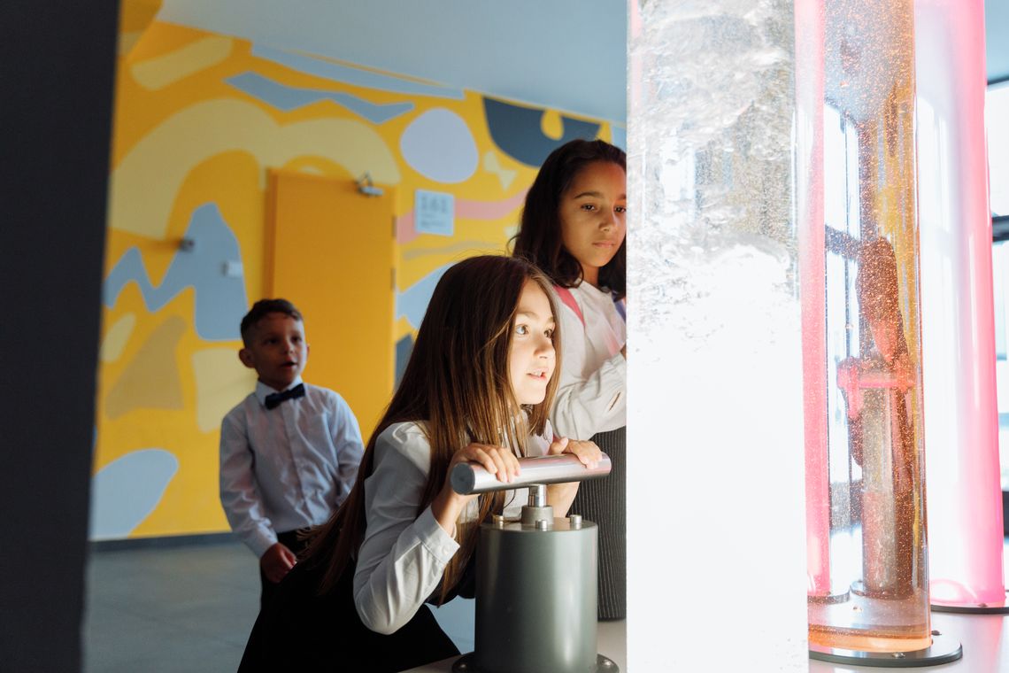 Children conducting a colorful hands-on science experiment at school