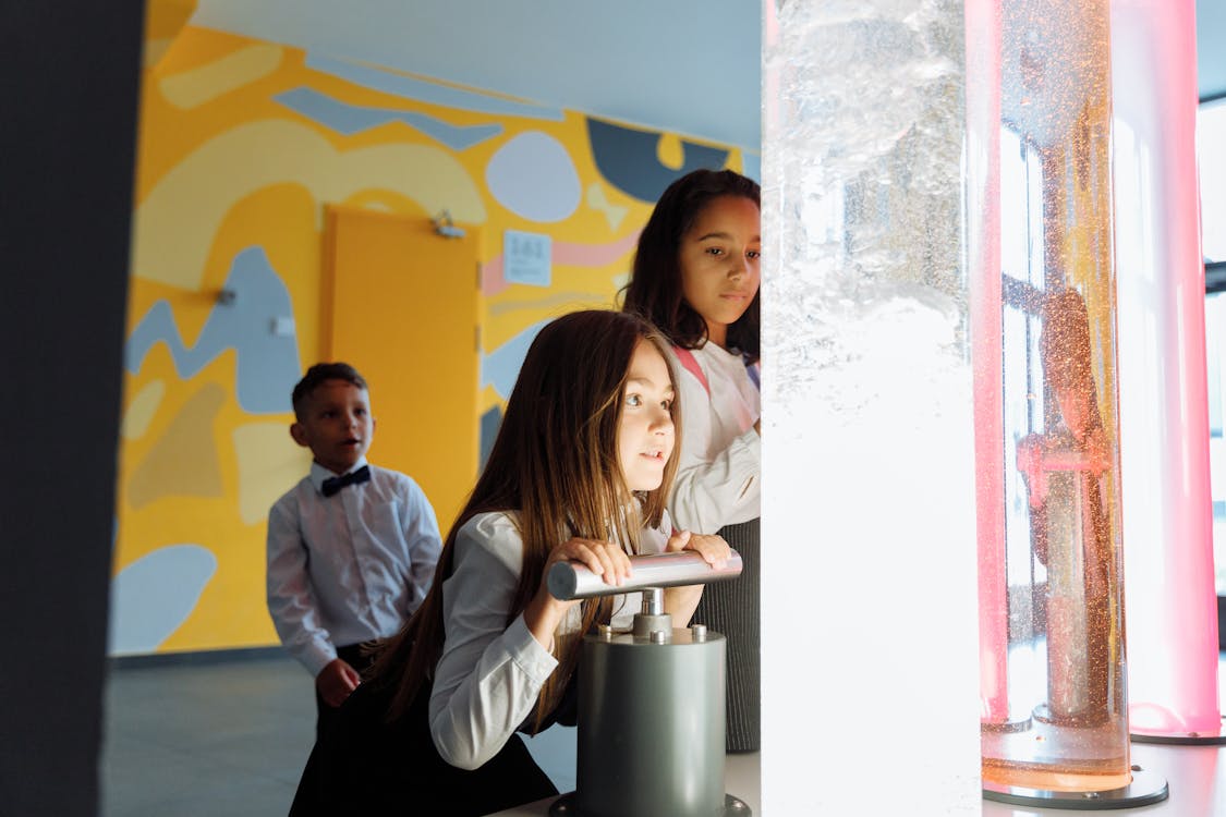 Free Children Playing with Colored Liquids inside the Container Stock Photo