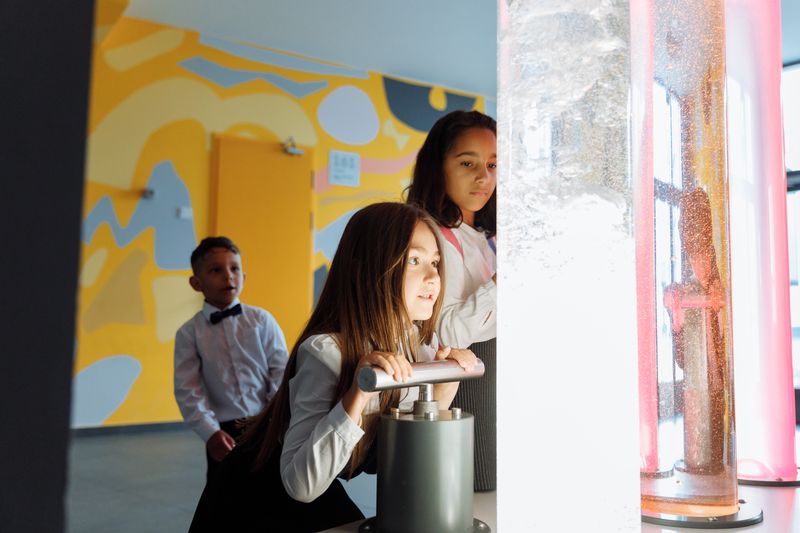 Children engaging in a science experiment with colored liquids