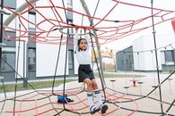 A Girl Playing in a Jungle Gym