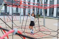 A Girl Playing in a Jungle Gym