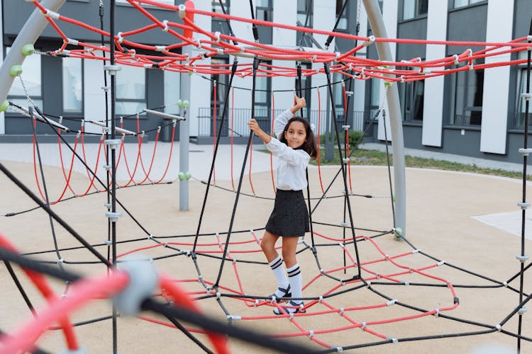 A Girl Playing In A Jungle Gym