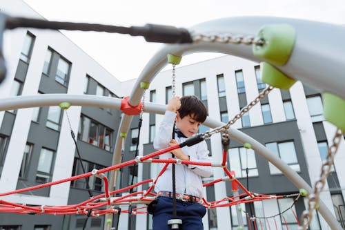 A Boy Playing in Jungle Gym