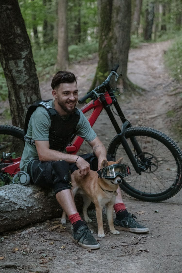 A Male Cyclist With His Dog