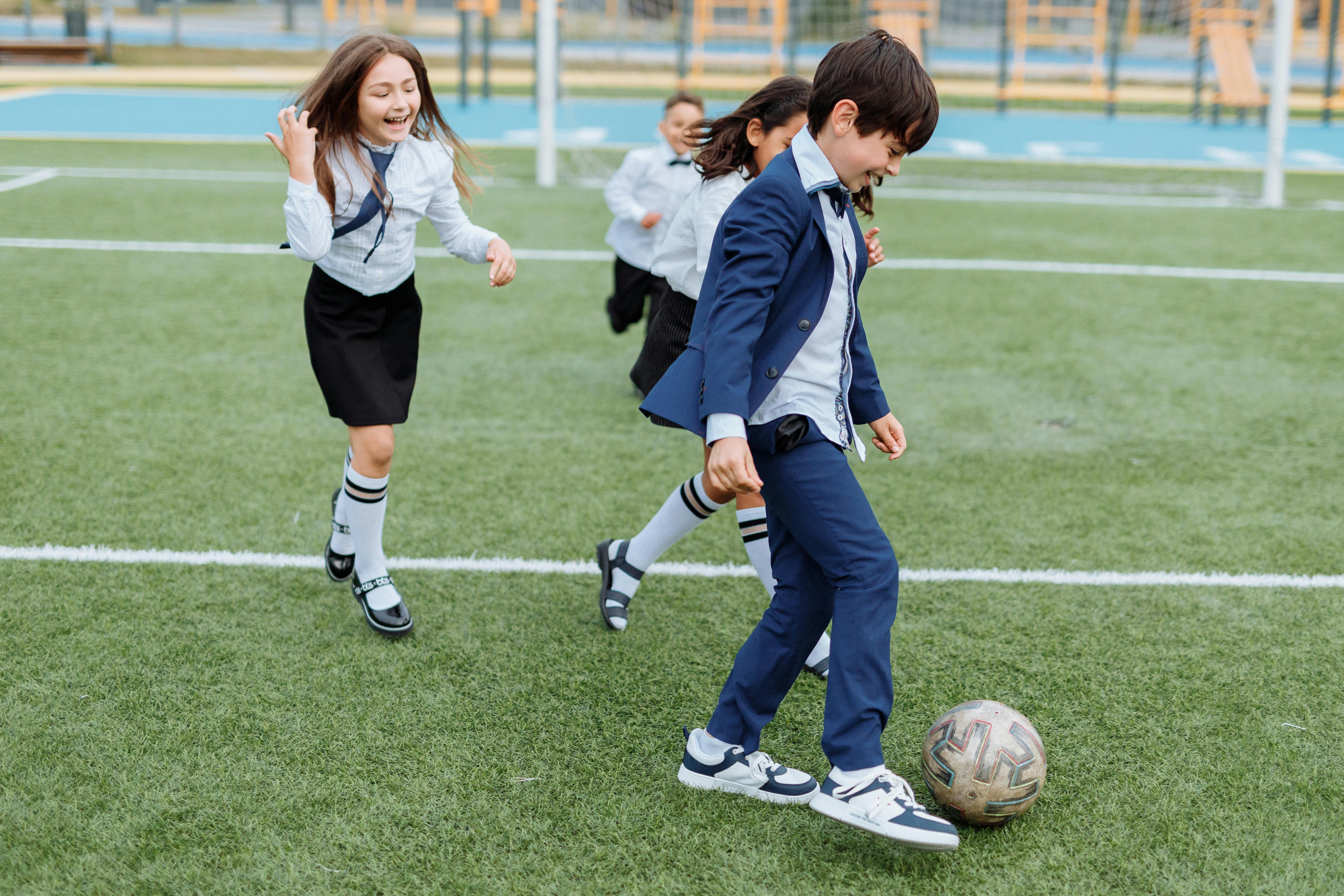 children having fun playing soccer