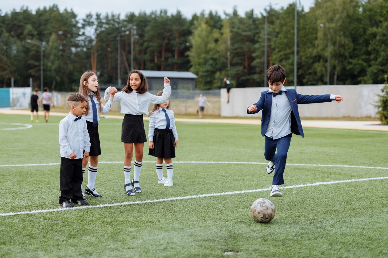 Children playing soccer outdoors