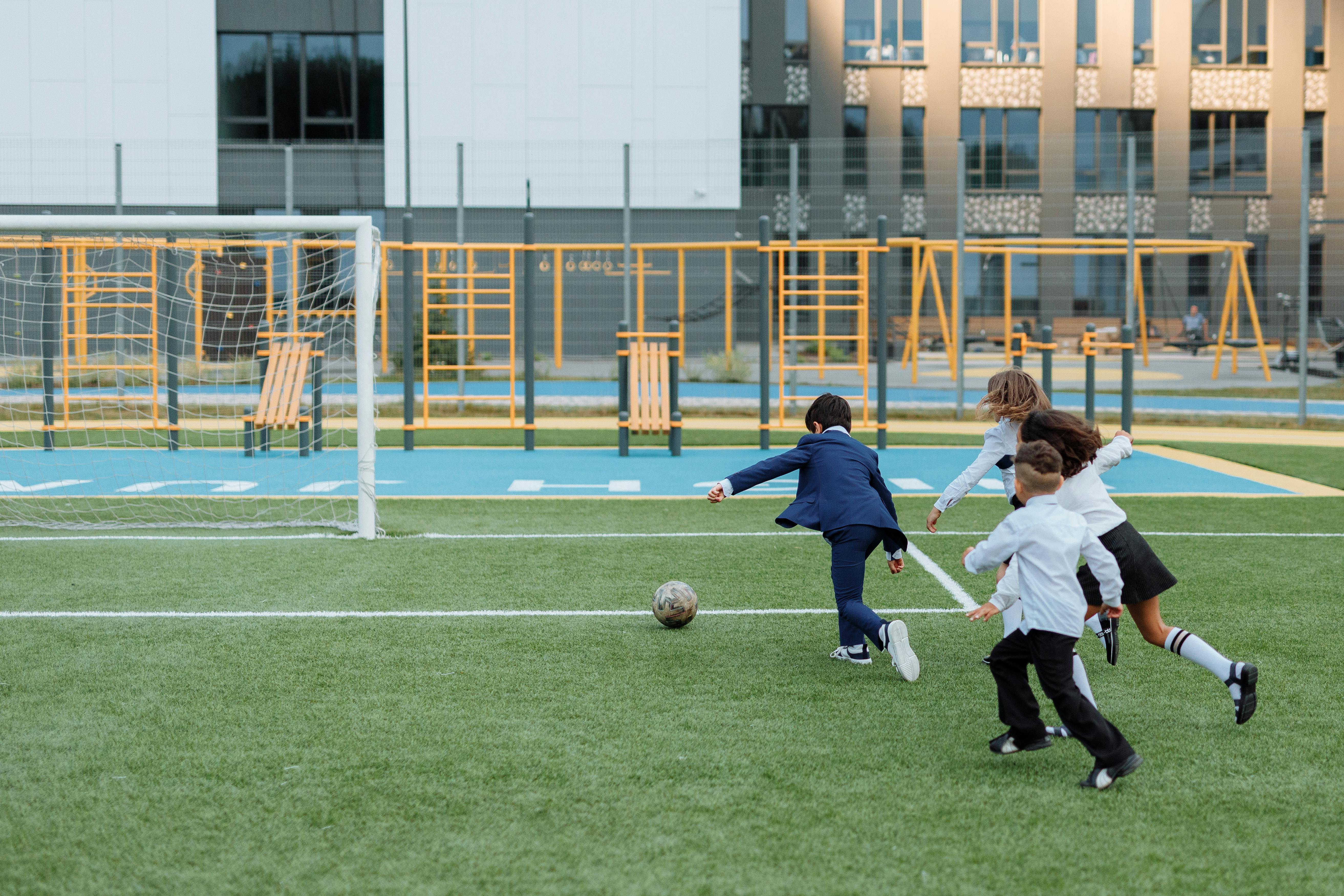 children having fun playing soccer