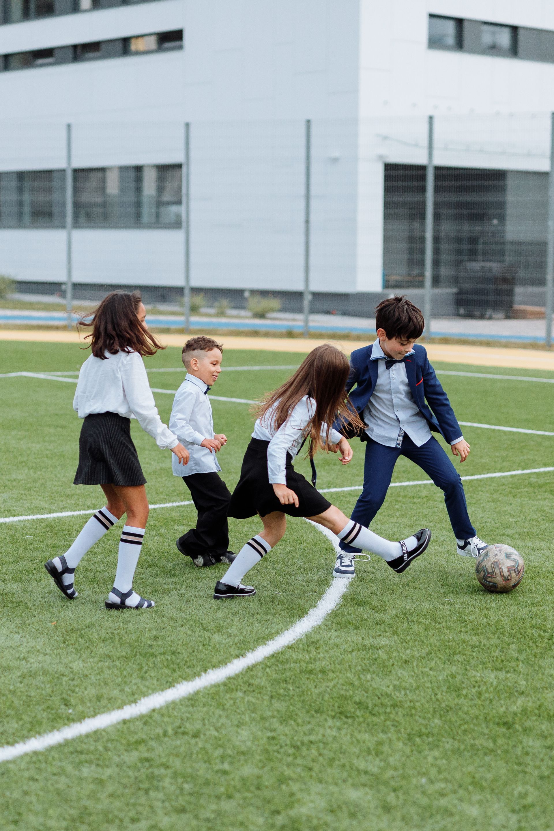 Children playing soccer at school