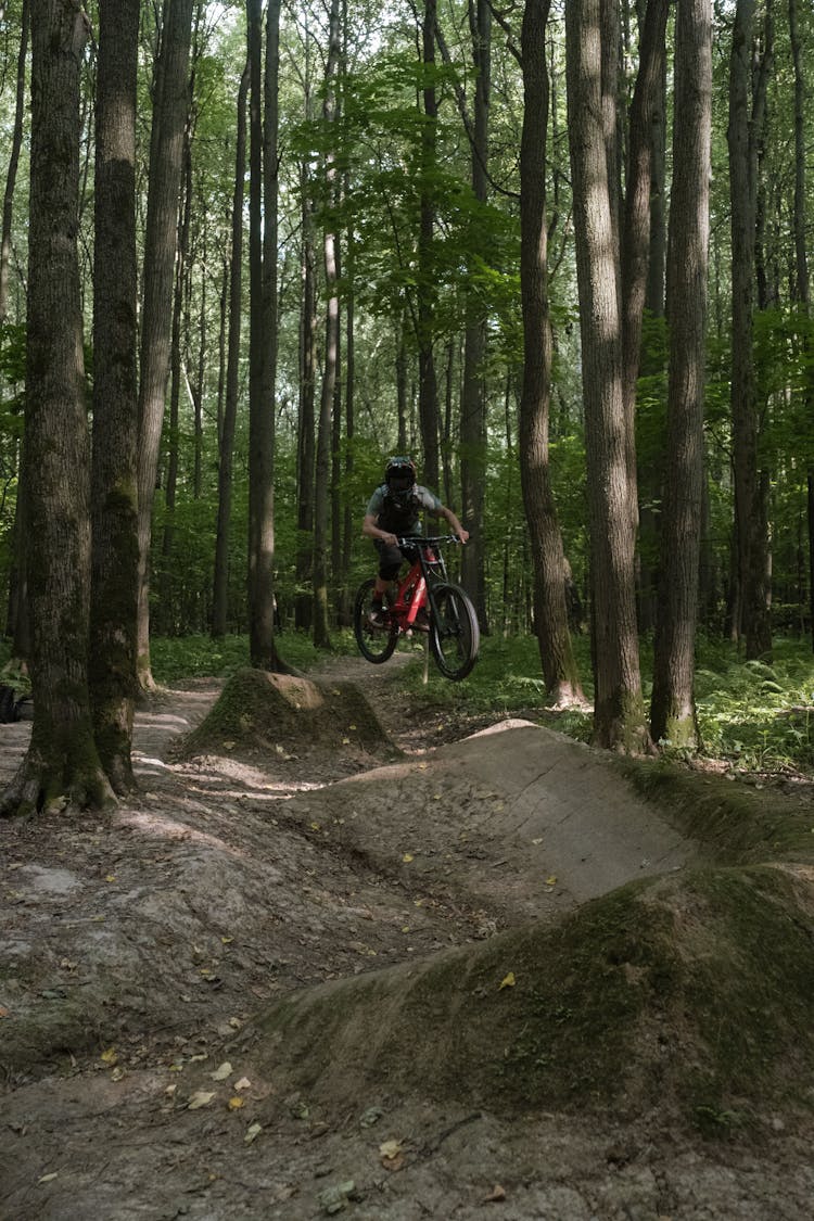 A Man Riding A Bicycle On The Bike Track