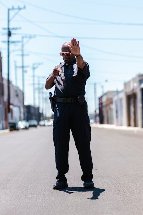 Free Photo of a Police Gesturing to Stop Stock Photo