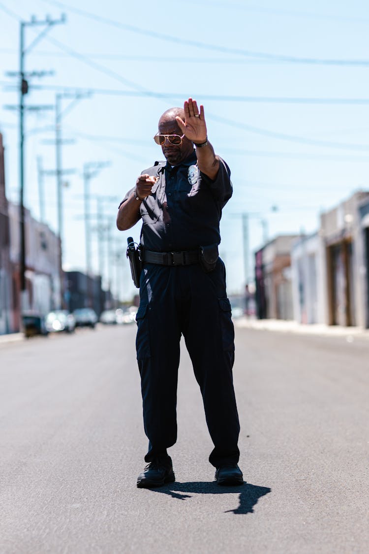 Photo Of A Police Gesturing To Stop