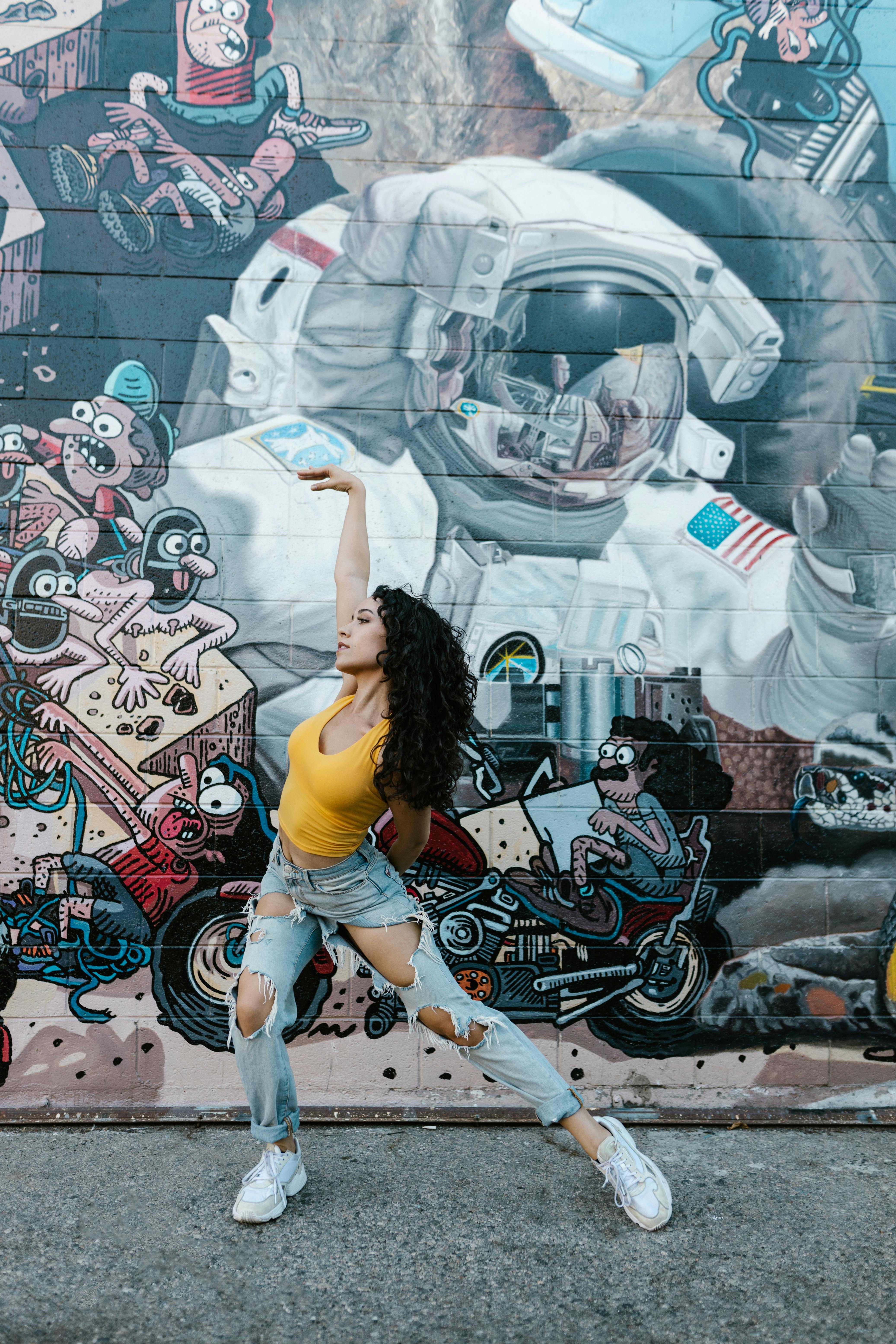 woman dancing with a graffiti wall background