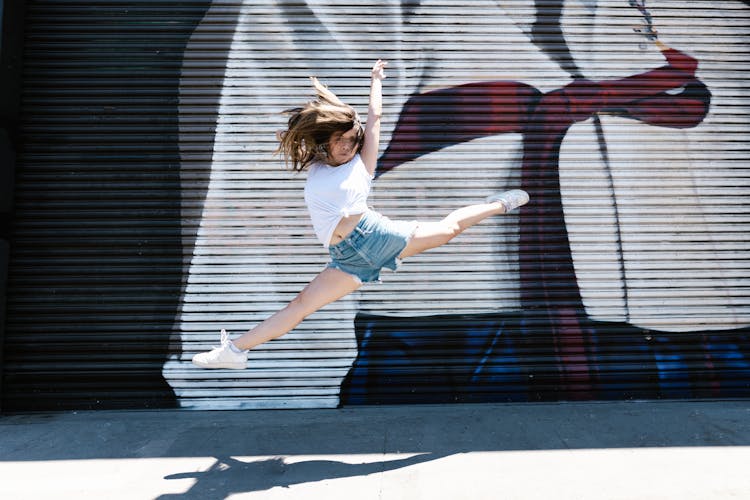 A Woman Jumping With Spread Legs