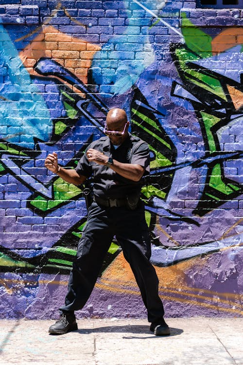 Free Bald-Headed Man Standing near a Graffiti Wall Stock Photo