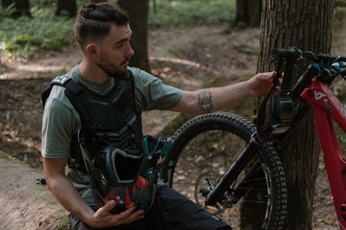 A Man Holding a Bike