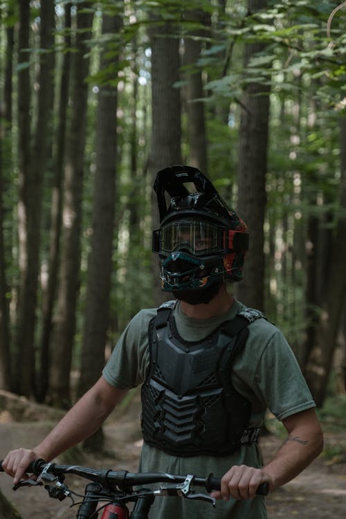 A Man Wearing a Bike Helmet in the Forest