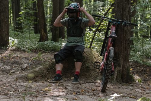 Free Cyclist taking a break on a forest trail with his mountain bike. Stock Photo