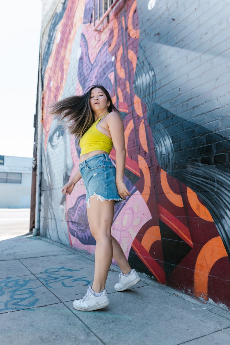 A Woman In Yellow Tank Top Turning Around