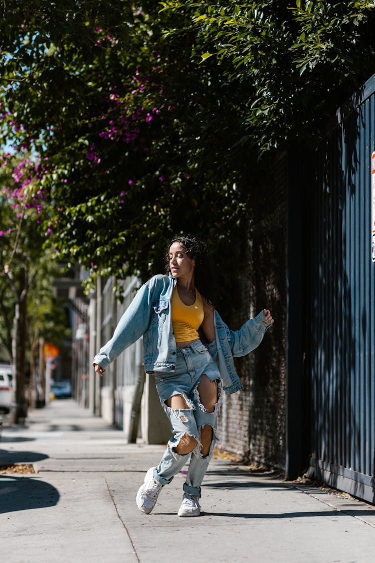 Young Woman Dancing On A Sidewalk 