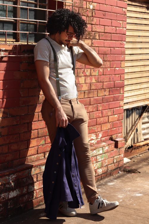 A Man Leaning on a Brick Wall · Free Stock Photo