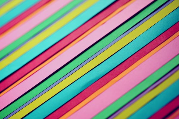 Diagonal bands of coloured paper forming a striped abstract pattern — Katie Rainbow on Pexels