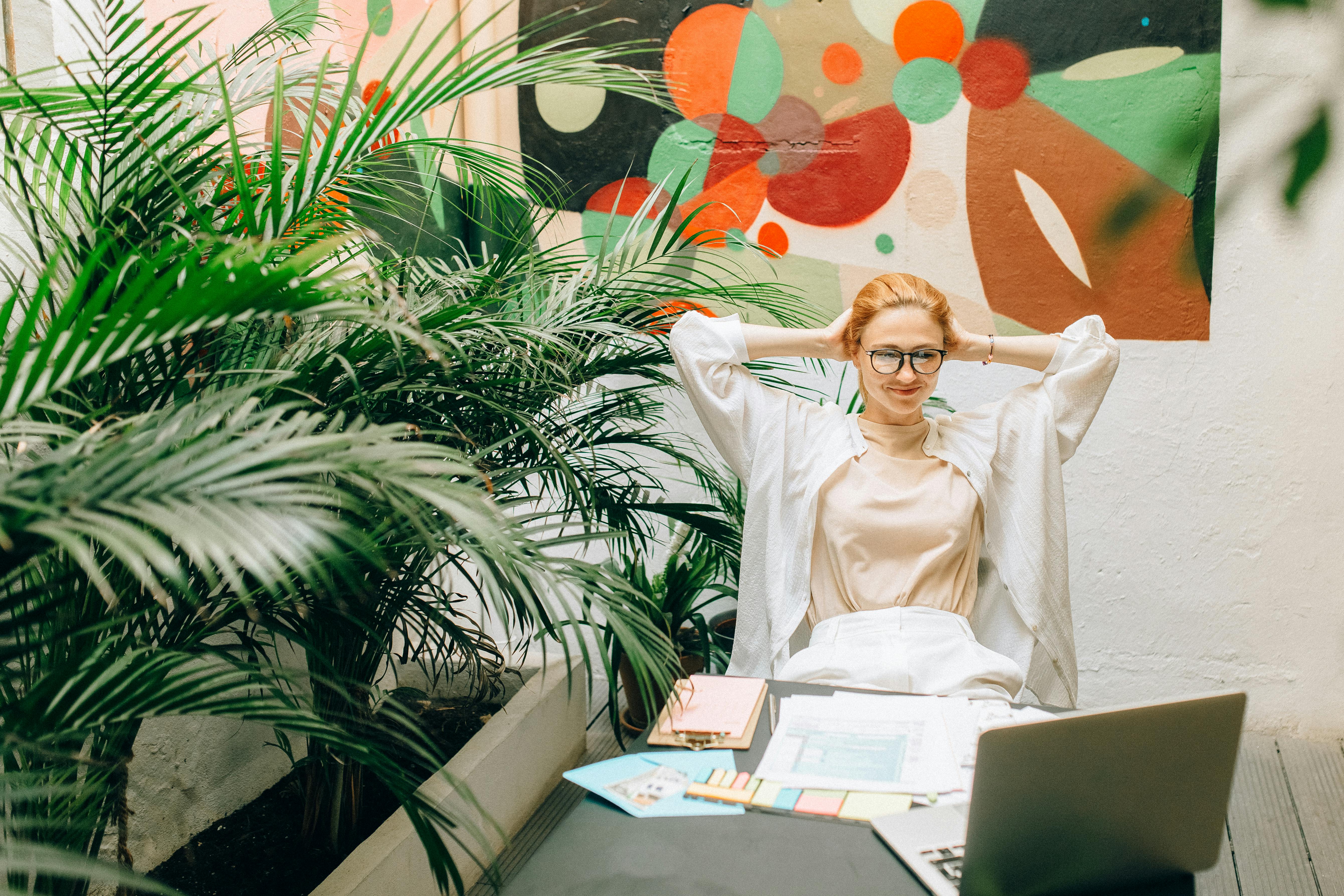 A Woman in White Long Sleeves Sitting on a Chair