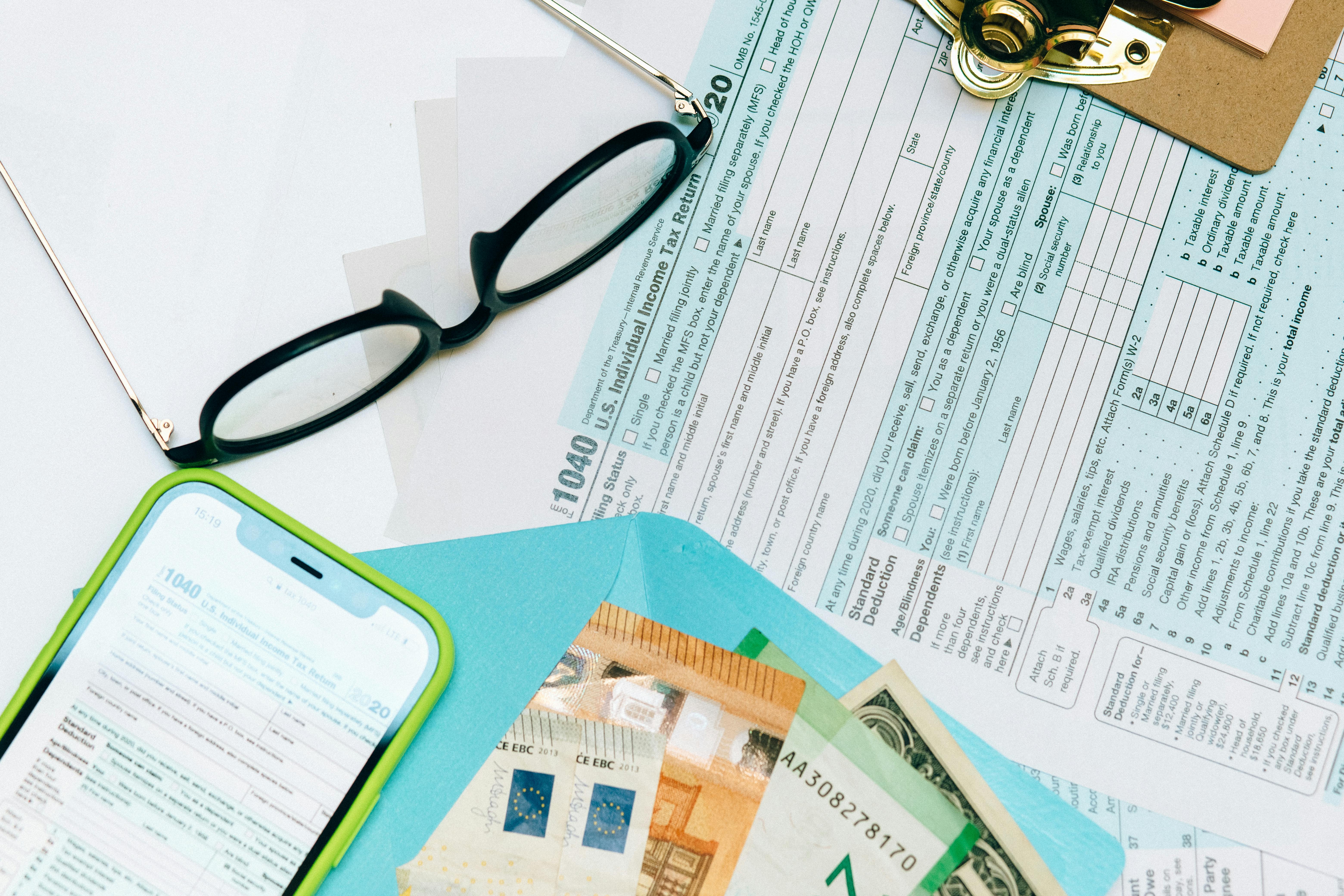 income tax return form beside black eyeglasses