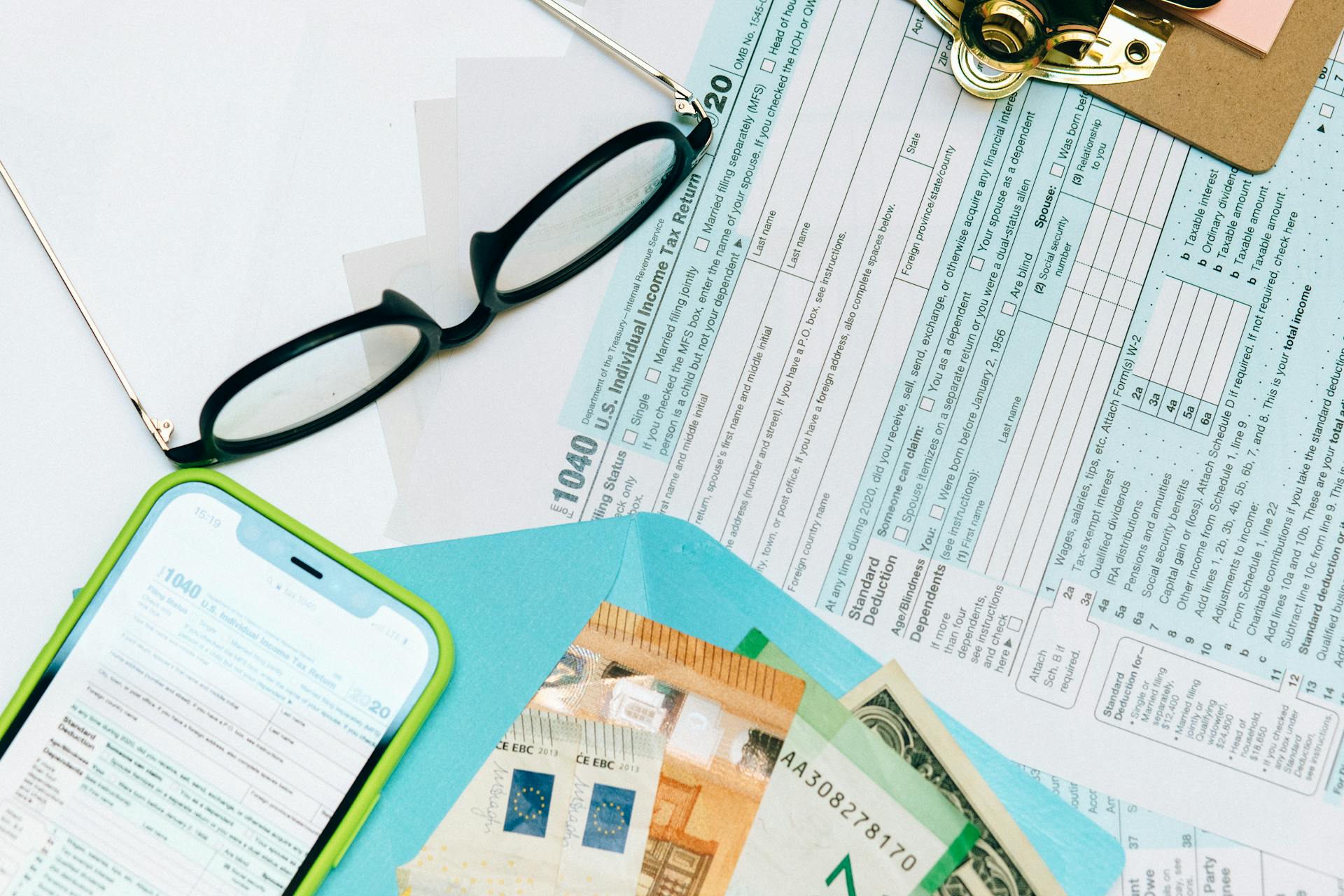 Income Tax Return Form Beside Black Eyeglasses