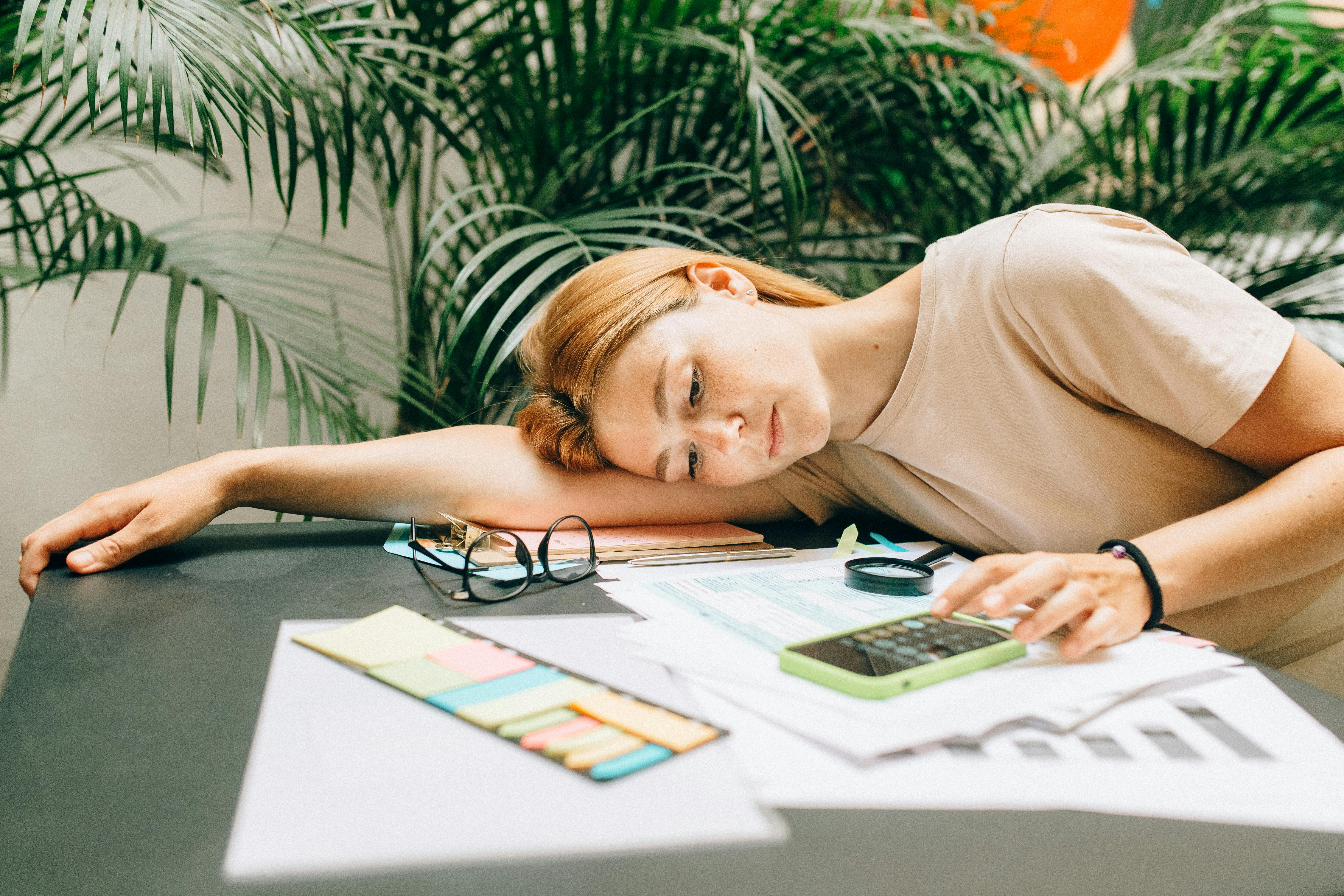 a woman using a calculator using smartphone