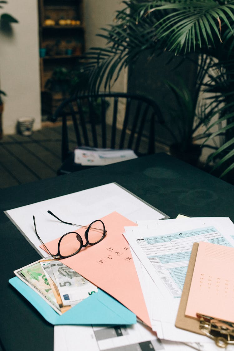 Papers And Eyeglasses On The Table