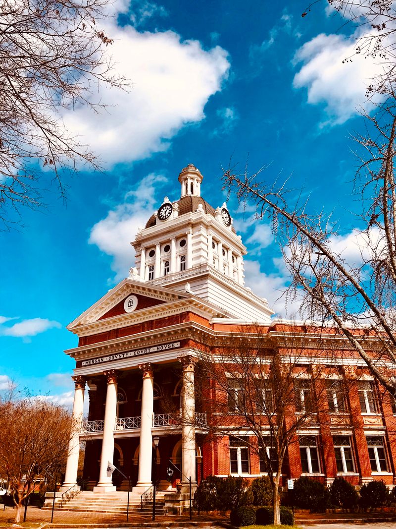 A stunning view of the historic courthouse in Madison, Georgia, framed by a vibrant blue sky