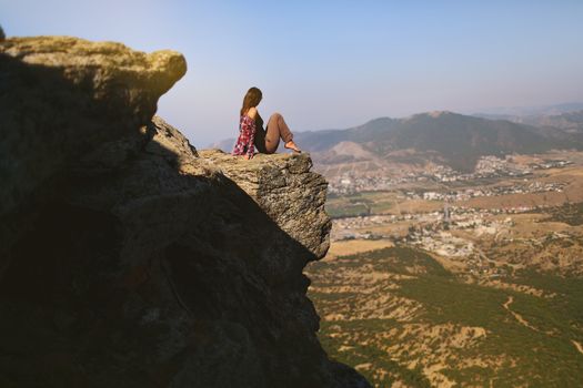 Woman in Red Long Sleeve Shirt Sitting on the Cliff